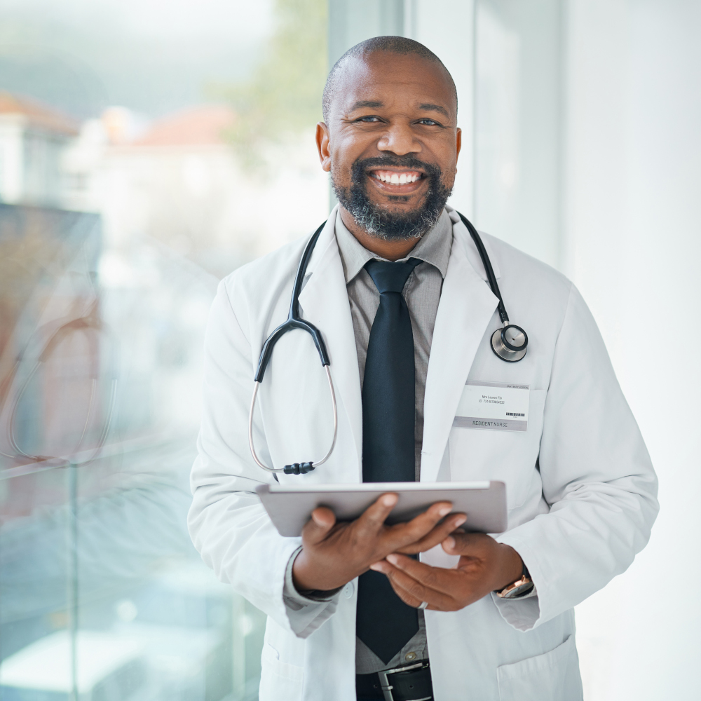 Doctors smiles with tablet in hand