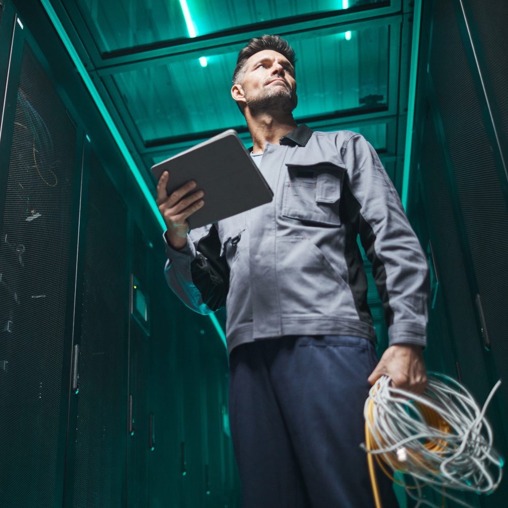 Man holds tablet and wires