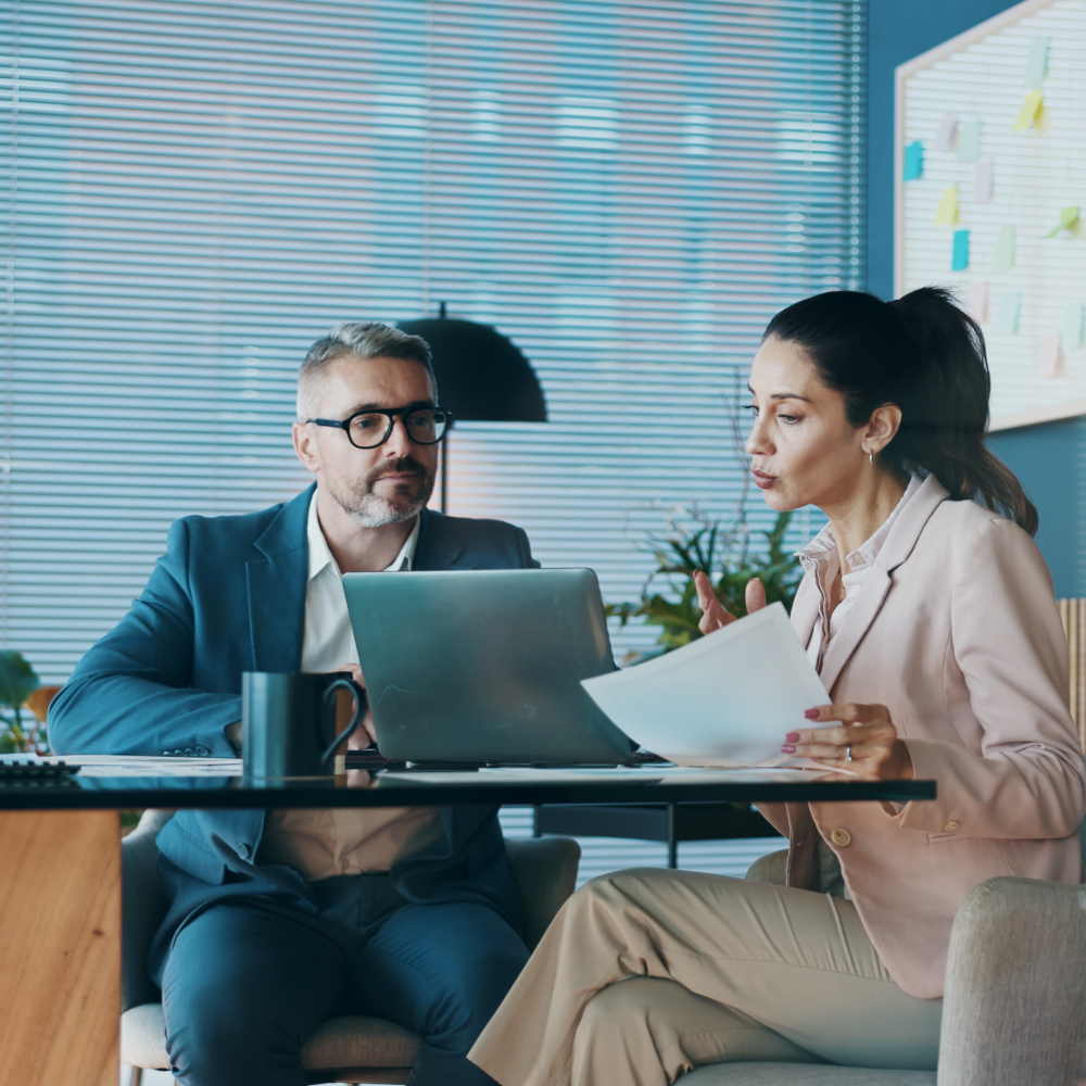 Man and women look at laptop