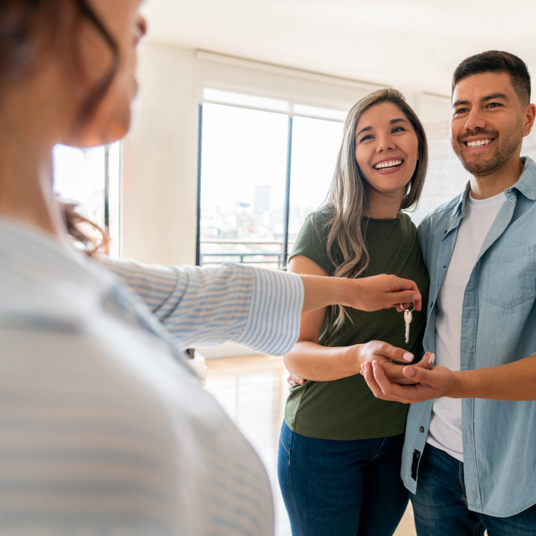 Women hands keys to couple