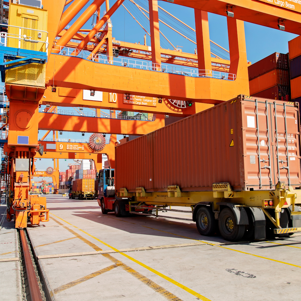 Shipping container being moved by truck