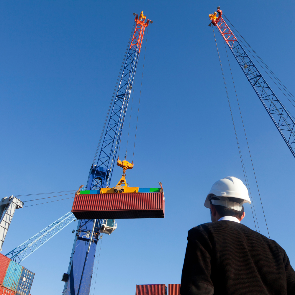 Shipping container held by crane