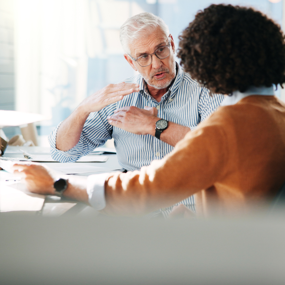 Woman talks to man making hand motions