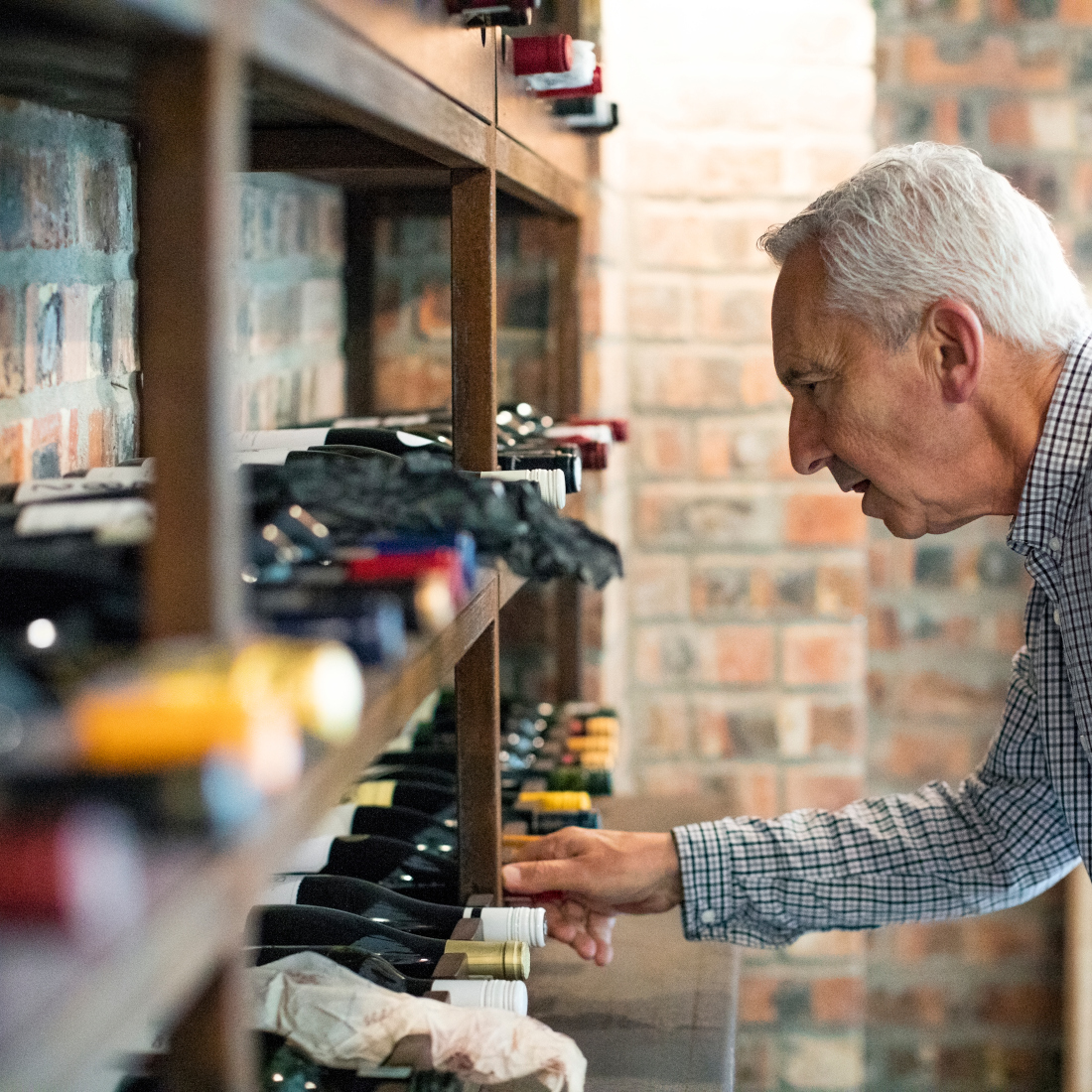 Man looks at wine on rack