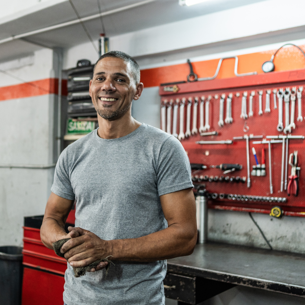 Man stands in front of tools and workbench