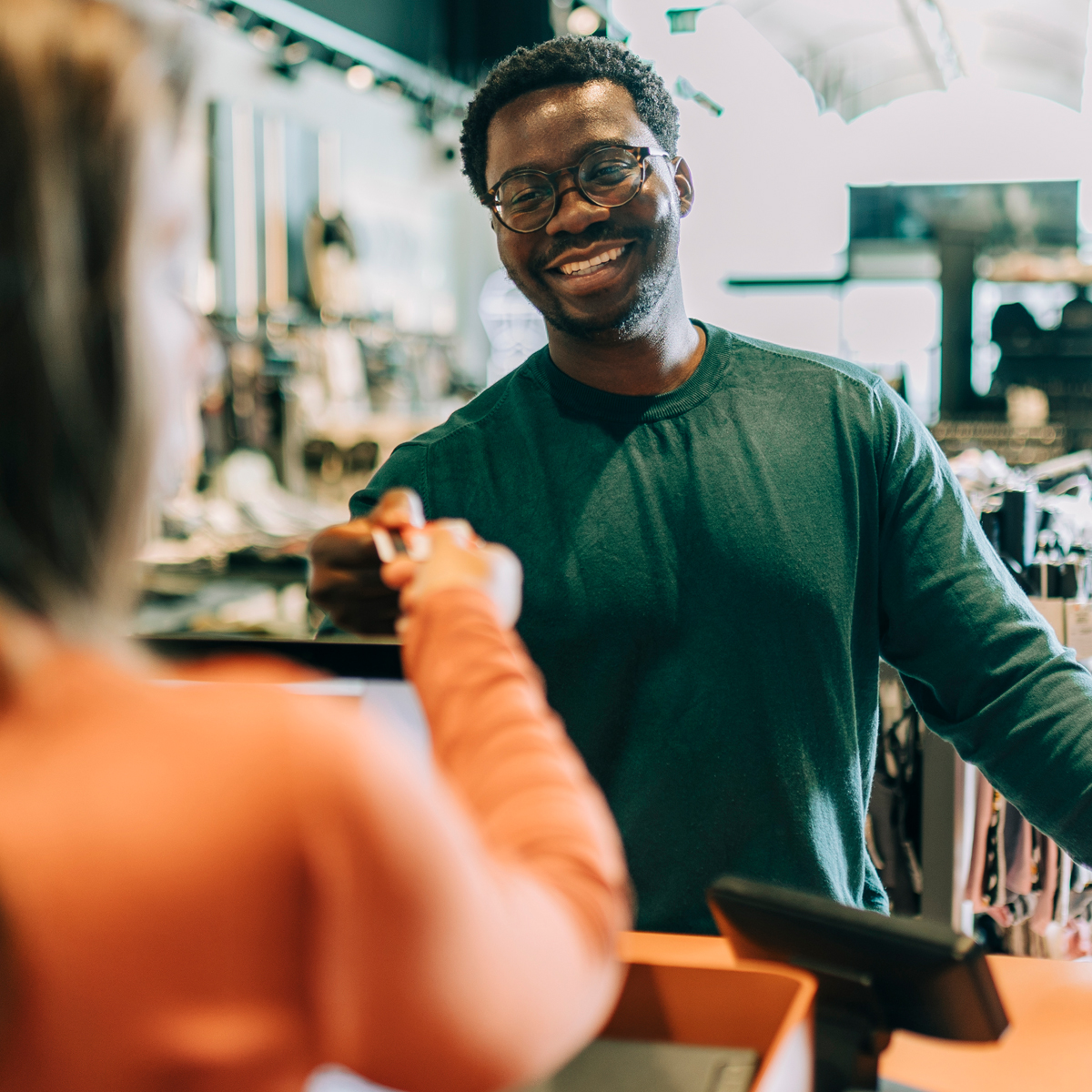 Man hands card to cashier